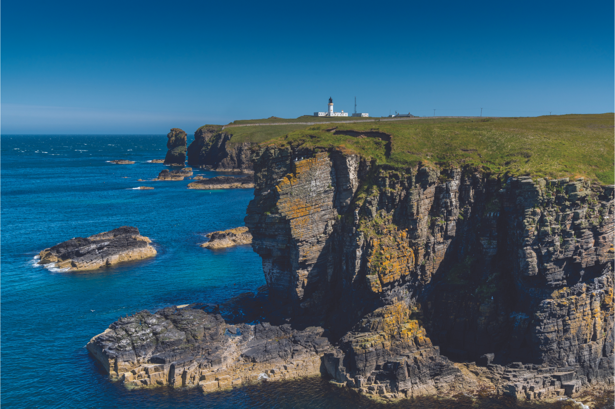 https://oldpulteney.com/wp-content/uploads/2023/08/View-of-the-Wild-Caithness-Coast-and-the-Noss-Head-Lighthouse.png