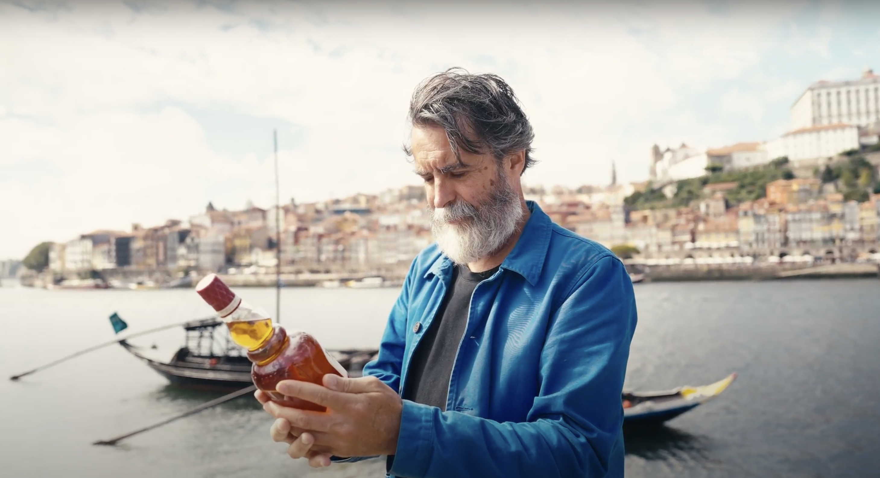 renowned Portuguese Michelin-star chef Nuno Mendes holding a bottle of Old Pulteney Port